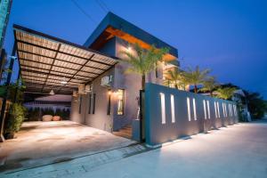 a house with a gate in front of a building at Playa Huahin by Ying in Hua Hin