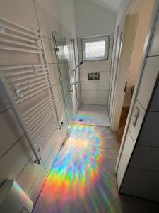 a rainbow colored floor in a bathroom with a shower at Königshof Studio in Monschau +28 photos