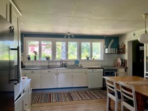 a kitchen with a sink and a table in it at Visseltofta old café - unexpected and picturesque in Osby
