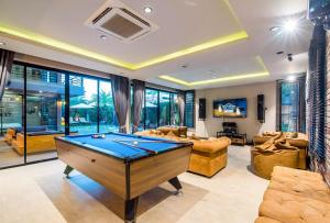 a living room with a pool table in it at Playa Huahin by Ying in Hua Hin