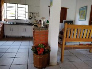 a kitchen with a bench and a table and a kitchen at Miracatu! Refúgio e Paz nas Montanhas in Miracatu +19 photos