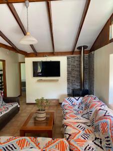 a living room with a couch and a tv at Elqui LU ASPAR in Vicuña