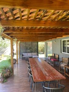 an outdoor patio with a wooden table and chairs at Elqui LU ASPAR in Vicuña