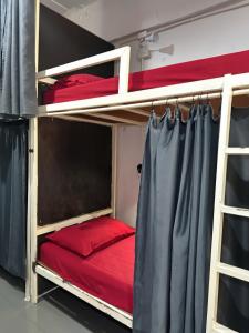 two bunk beds in a room with red sheets at Magic Hostel in Phi Phi Islands +46 photos