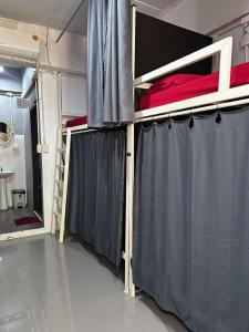 a room with two bunk beds and a window at Magic Hostel in Phi Phi Islands