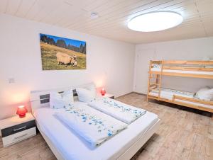 a bedroom with a bed and two bunk beds at Gasthaus und Hotel Peterhänsel in Spechtsbrunn