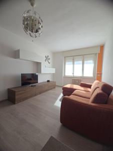 a living room with a couch and a flat screen tv at Il Ciano in Sondrio