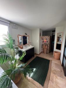 a living room with a vanity and a mirror at La Bastide de Grosille in Savasse