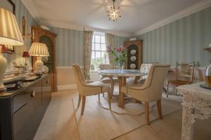 a dining room with a table and chairs at Virginia Cottage in York