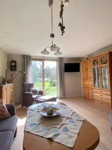a living room with a table and a couch at Meyer im Moor in Grasberg