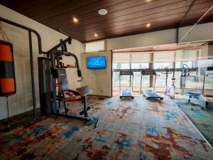 a gym with several treadmills and machines in a room at Friends Hotel Jordan in Amman