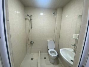 a bathroom with a shower and a toilet and a sink at Ruslan Hootel 3 in Poti