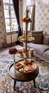a table with three plates of food on it in a living room at De Tegel Suite in Anjum