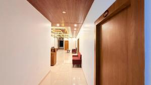 a hallway in a hospital with a door and chairs at Hotel Blessing Inn & Restaurant in Prayagraj