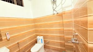 a bathroom with a toilet and a sink at Hotel Blessing Inn & Restaurant in Prayagraj