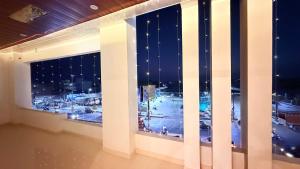 a window with a view of a city at night at Hotel Blessing Inn & Restaurant in Prayagraj
