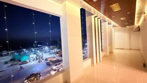 a room with a view of a city at night at Hotel Blessing Inn & Restaurant in Prayagraj +8 photos