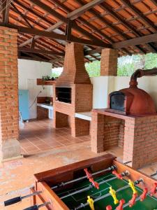 an outdoor kitchen with an outdoor oven with a table at Sítio Toca da Pedra in Pedra Bela