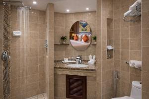 a bathroom with a sink and a mirror at Pacific Club Resort in Karon Beach