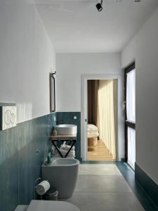 a bathroom with a toilet and a sink at Vico Suite in Santa Maria a Vico +49 photos