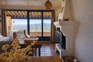 a living room with a fireplace and a view of the mountains at Loft con chimenea y terraza con vistas - Cal Caterino in Montsonis +25 photos