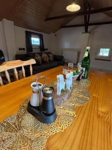 a living room with a table with a bottle of wine at Tiny House mit Garten und Sauna in Karbach +6 photos