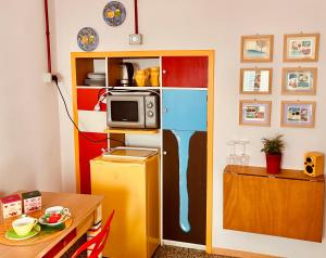 a kitchen with a refrigerator and a microwave at Il balconcino di Riamori in Amelia +7 photos