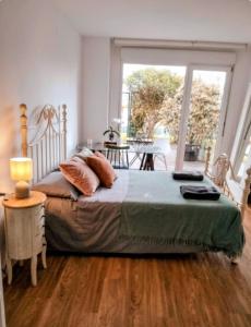 a bedroom with a bed and a large window at Oasis de Sal y Pradera in Miengo