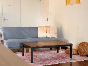 a living room with a couch and a coffee table at Pavilion Beachfront in Shishikui