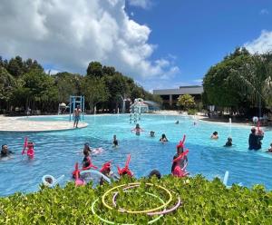 a group of people swimming in a swimming pool at Iloa Residence V13 Beach - localização privilegiada in Barra de São Miguel