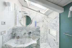 a bathroom with a sink and a mirror at Nus Hotel Poerio in Rome +62 photos