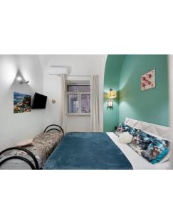 a bedroom with a bed and a window at Casetta FRM home in Naples
