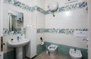 a bathroom with a sink and a toilet at Casetta FRM home in Naples +11 photos