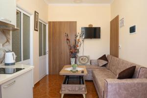 a living room with a couch and a table at Apartment Darlin Berat in Berat