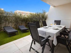 a table with a white table cloth on a patio at Eden50 in Mijas Costa