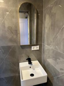 a bathroom with a sink and a mirror and a tub at Villa Violand 3 in Limanu +10 photos