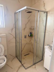 a shower with a glass door in a bathroom at Veloura in Ulcinj +36 photos