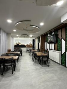 a restaurant with tables and chairs in a room at Srebrna Jela in Žabljak