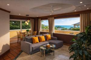 a living room with a couch and a table at Pacific Club Resort in Karon Beach
