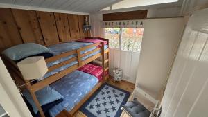 a small room with two bunk beds and a window at Chalet 24 in Seaton