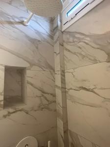 a bathroom with marble walls and a ceiling at Sarti Paradise in Sarti +44 photos