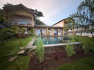 a house with a swimming pool in the yard at Villa Baby lodge in Hell-Ville