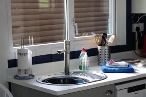 a kitchen counter with a sink and a window at Chalet 24 in Seaton +17 photos