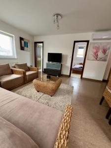 a living room with a couch and a table at Marilyn Apartman Gyenesdiás in Gyenesdiás