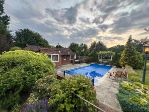 a house with a swimming pool in a yard at The pool house in Bedford