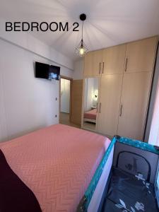 a bedroom with a bed and a room with a television at Castle view 2 in Kavála +2 photos