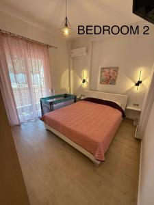 a bedroom with a bed and a window at Castle view 2 in Kavála