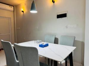 a dining room table with chairs and a white counter top at Rihiveli Palace in Maamigili