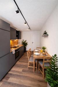 a kitchen and dining room with a table and chairs at der Untermühlbacher in Gnesau