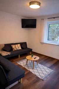 a living room with a couch and a table at der Untermühlbacher in Gnesau